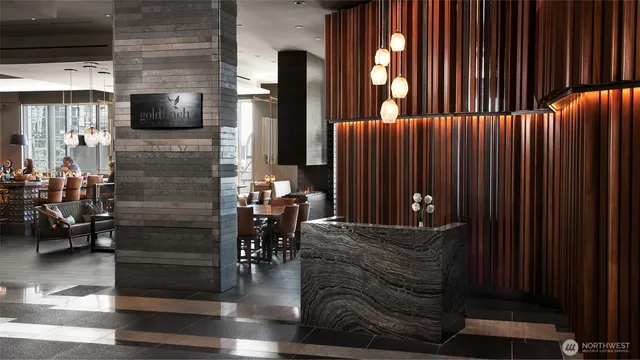 a view of a lake with a table and chairs under an umbrella