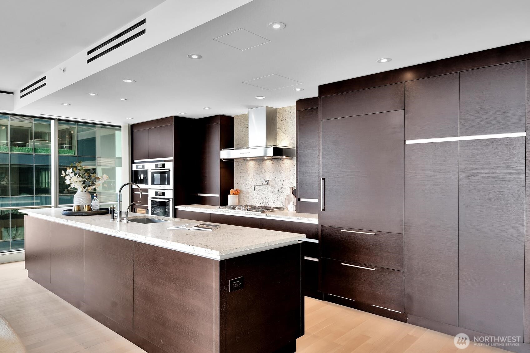 99 Union Street, Unit 1205 & 1206 Seattle, WA 98101 - Photo 4 of 40 a kitchen with stainless steel appliances granite countertop a sink and a refrigerator