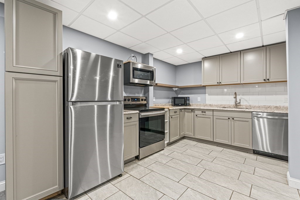 288 Mill Street Newton, MA 02460 - Photo 24 of 35 a kitchen with a refrigerator sink and cabinets