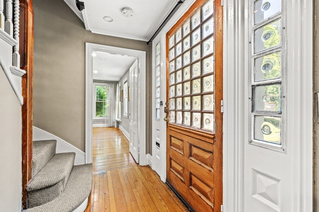 288 Mill Street Newton, MA 02460 - Photo 4 of 35 a view of a hallway with wooden floor and staircase