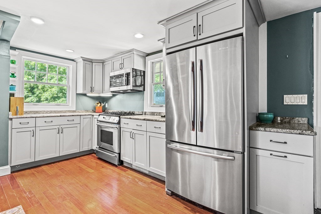 288 Mill Street Newton, MA 02460 - Photo 7 of 35 a kitchen with white cabinets and white appliances