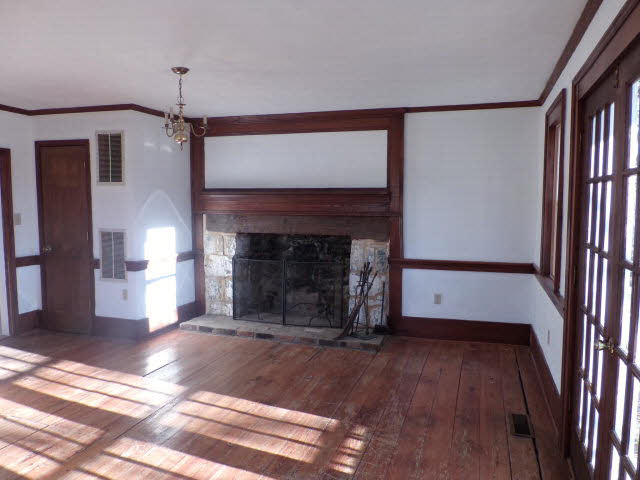 10982 Back Road Maurertown, VA 22644 - Photo 16 of 35 a view of an empty room with wooden floor fireplace and a window