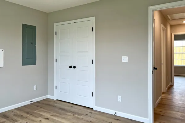 a view of an empty room with wooden floor