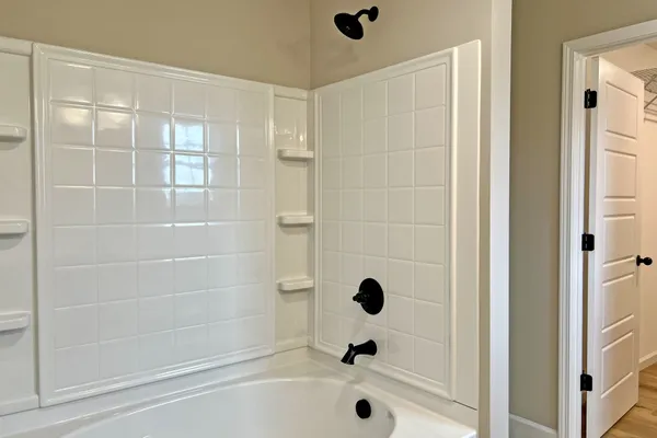 a bathroom with a tub and a shower