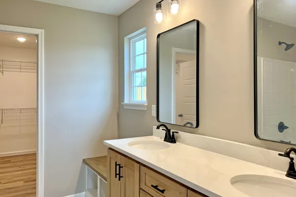 a bathroom with a sink vanity granite and a mirror