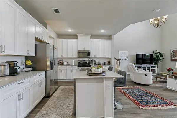 a kitchen with sink a stove and cabinets
