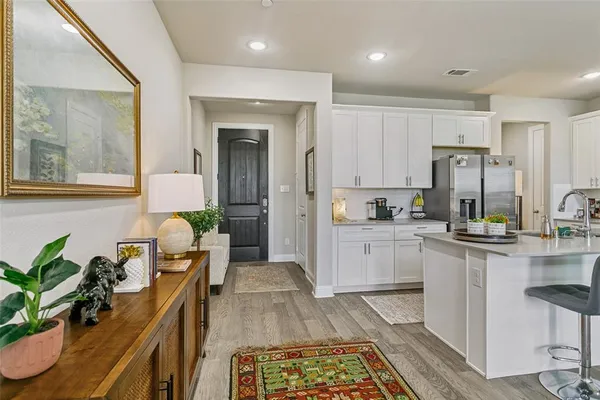 a kitchen with cabinets and wooden floor
