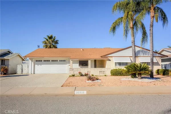a front view of a house with a yard and a garage