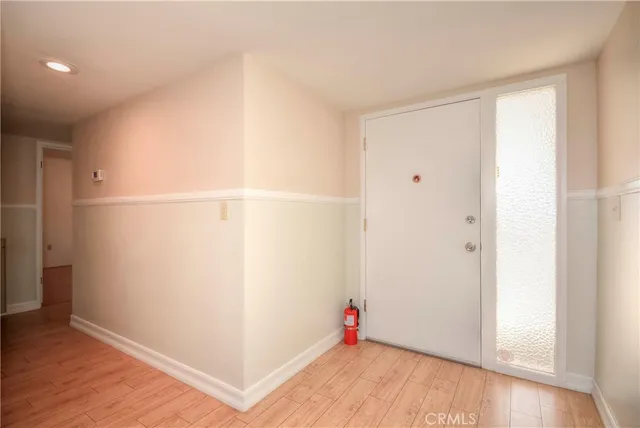 a view of empty room with wooden floor and floor to ceiling window