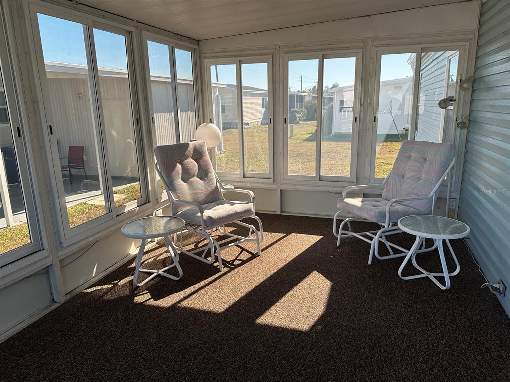 449 Landsedge Drive North Port, FL 34287 - Photo 11 of 12 a living room with furniture and a floor to ceiling window