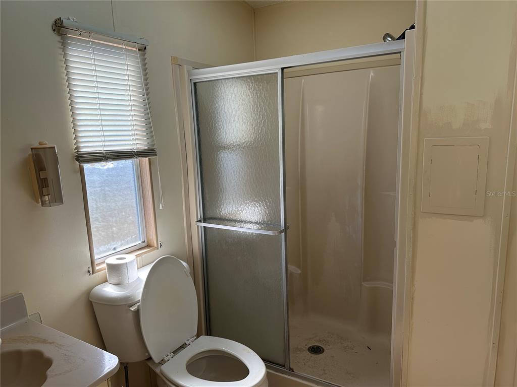 449 Landsedge Drive North Port, FL 34287 - Photo 7 of 12 a bathroom with a granite countertop toilet and a shower
