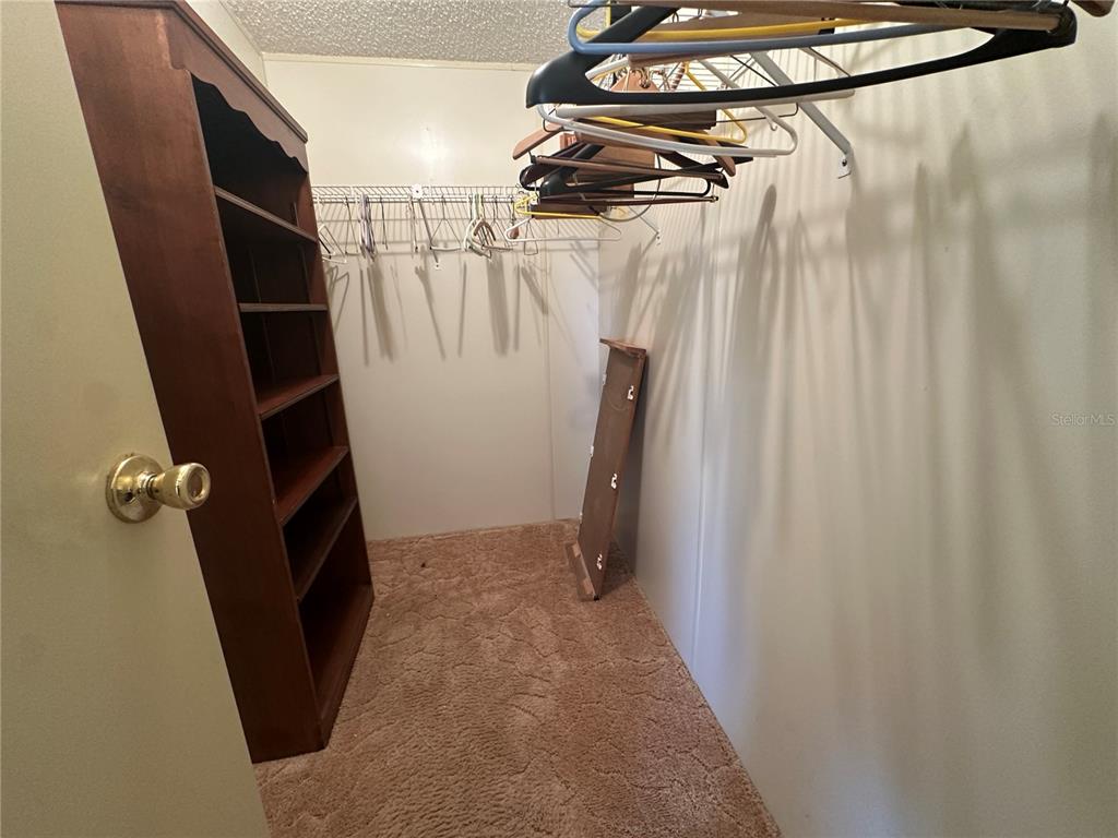 449 Landsedge Drive North Port, FL 34287 - Photo 8 of 12 a view of walk in closet with clothes and shoes