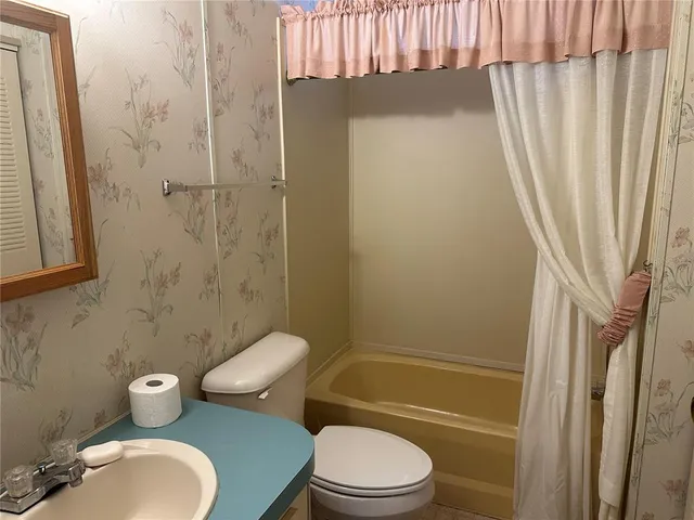 a bedroom with a bed and a chair