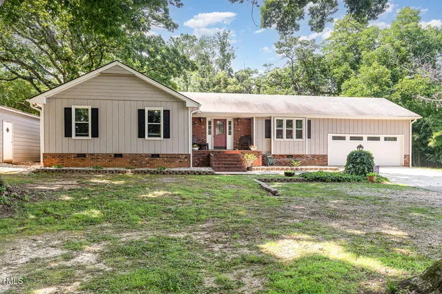 a front view of house with yard and green space