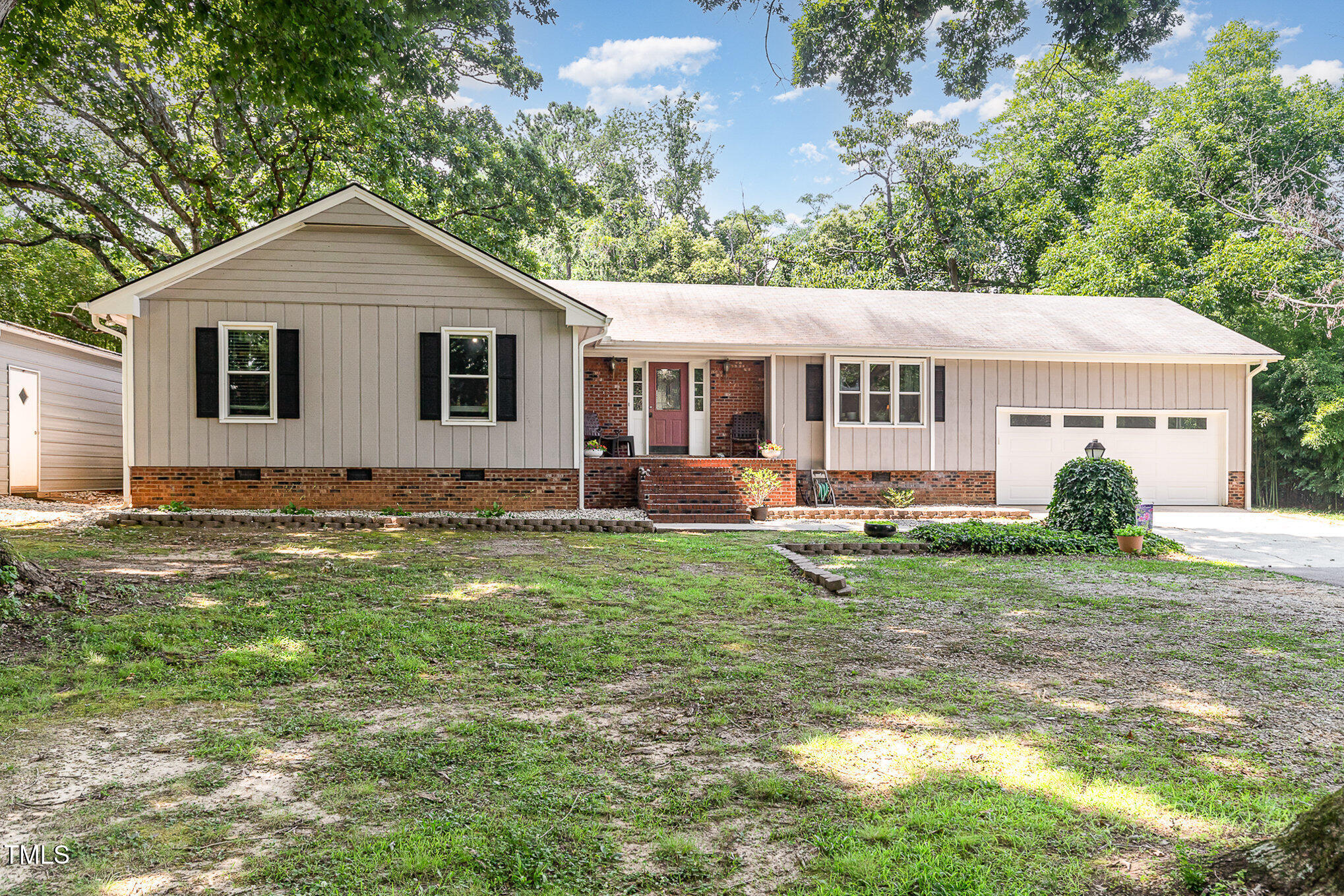 a front view of house with yard and green space