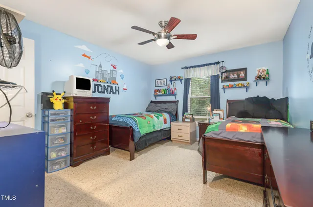 a bedroom with furniture and a window