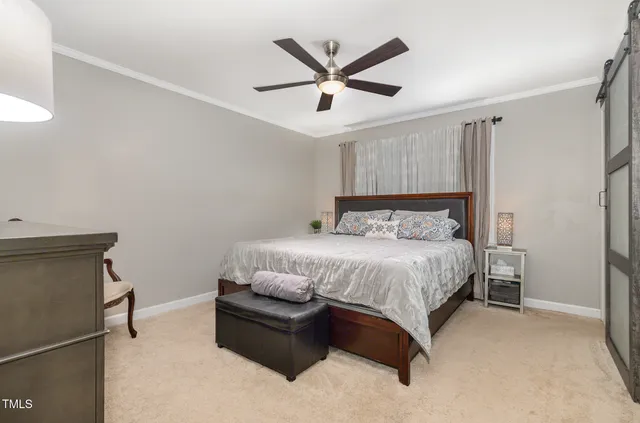 a bedroom with a bed and ceiling fan