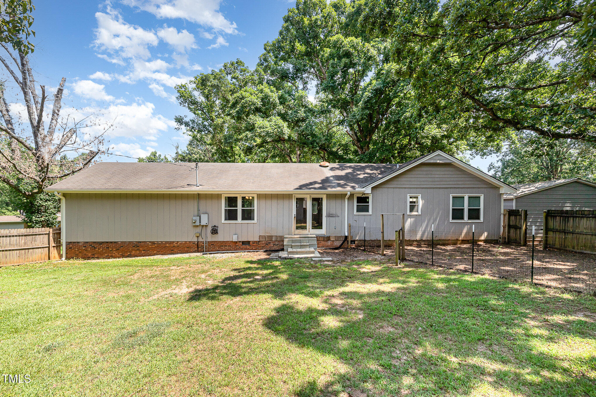 5840 Fayetteville Road Raleigh, NC 27603 - Photo 17 of 40 a front view of house with yard and trees in the background