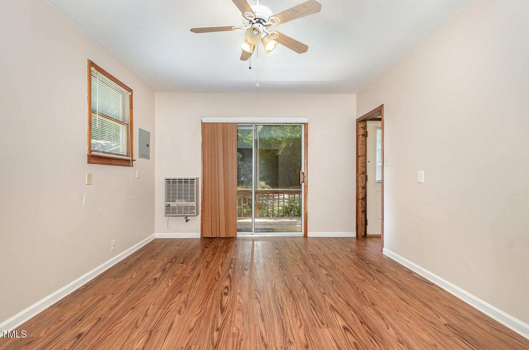 5840 Fayetteville Road Raleigh, NC 27603 - Photo 22 of 40 a view of an empty room with wooden floor and a window