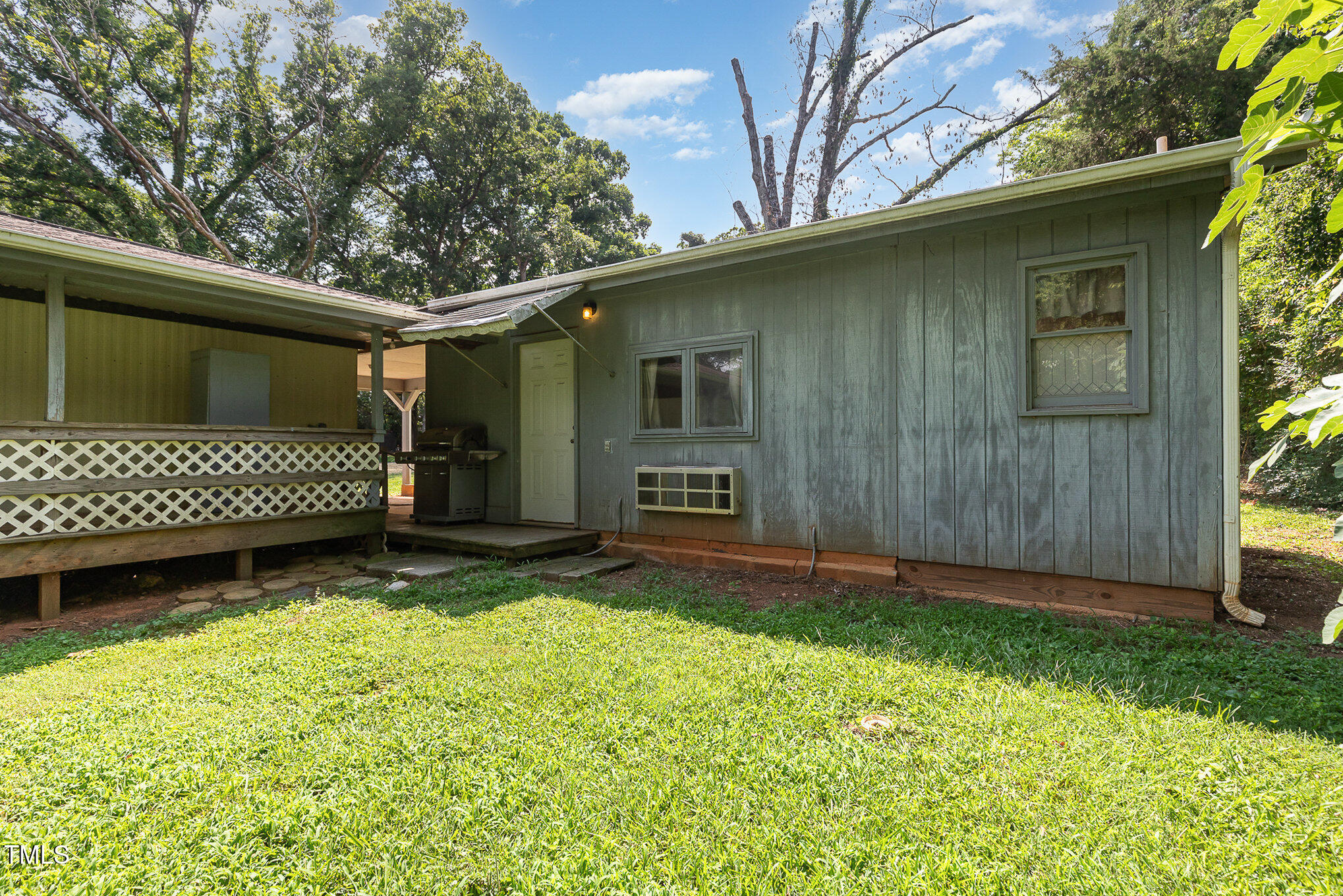 5840 Fayetteville Road Raleigh, NC 27603 - Photo 35 of 40 a view of a backyard with a large tree and wooden fence