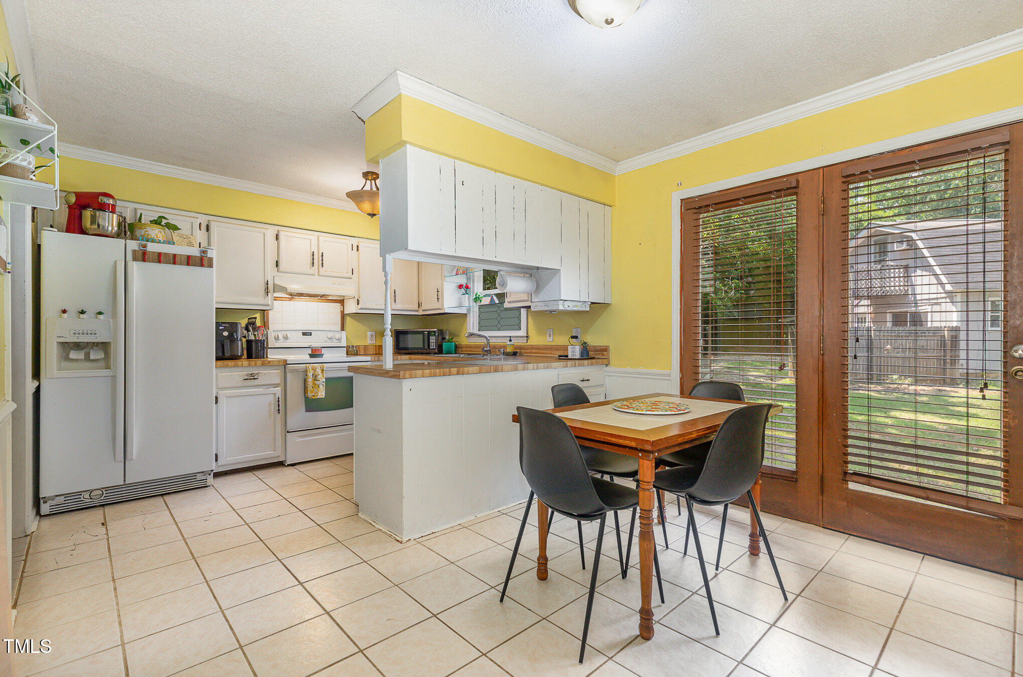 5840 Fayetteville Road Raleigh, NC 27603 - Photo 8 of 40 a kitchen with stainless steel appliances kitchen island granite countertop a table chairs sink and cabinets