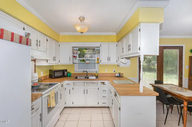 a kitchen with a sink a stove cabinets and counter space