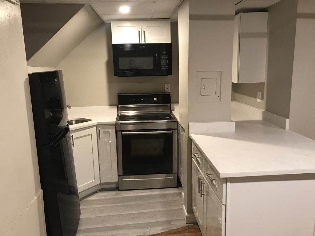 a kitchen with a stove microwave and refrigerator