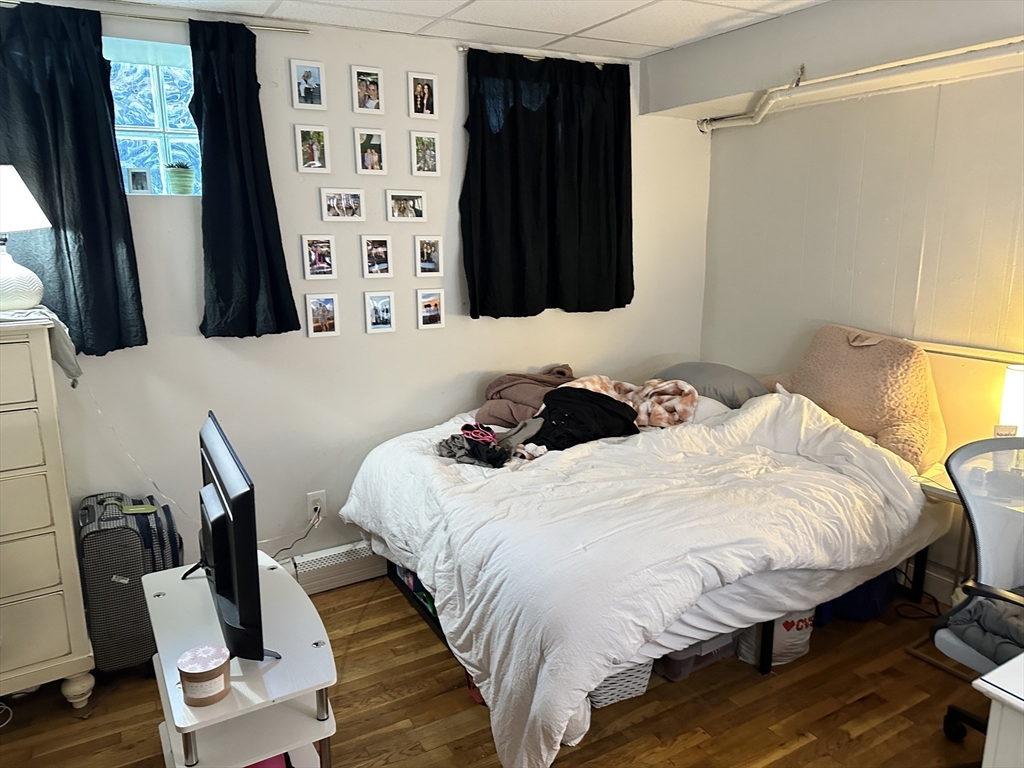 15 Aberdeen Street, Unit AB Boston, MA 02215 - Photo 4 of 7 a bedroom with a bed window and a chair