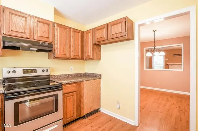 a kitchen with granite countertop a stove and a refrigerator