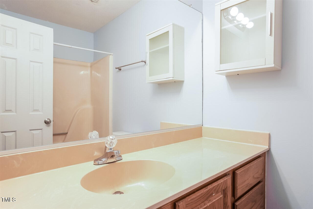 551 Oak Run Drive Raleigh, NC 27606 - Photo 10 of 13 a bathroom with a sink and a mirror
