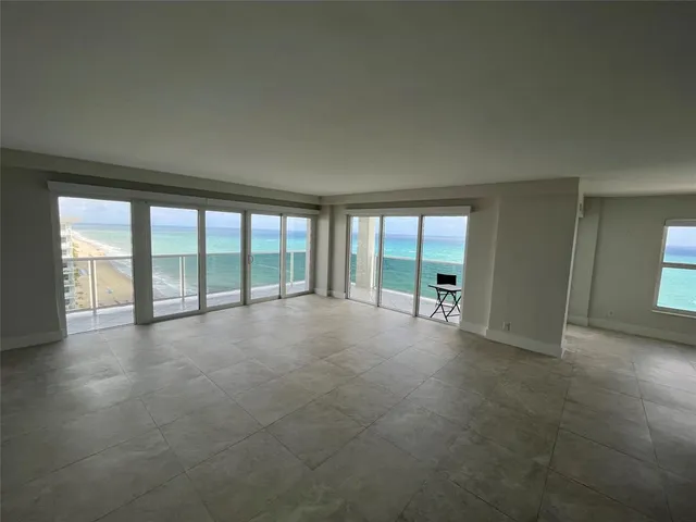 a large white kitchen with cabinets