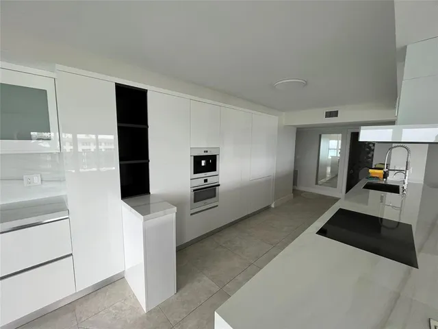 a bathroom with a double vanity sink and mirror