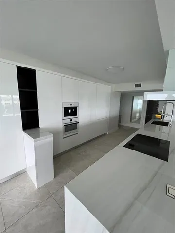 a bathroom with a toilet a sink and shower