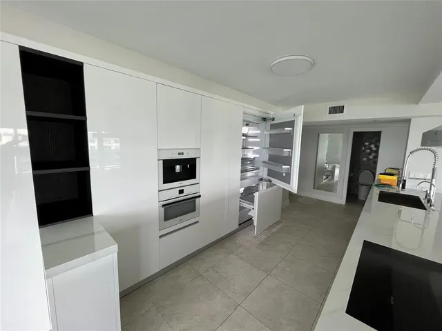 a bathroom with a bathtub double vanity sink and mirror