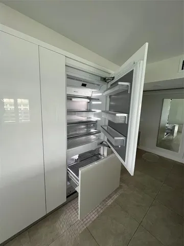 a bathroom with a double vanity sink a mirror and a bathtub