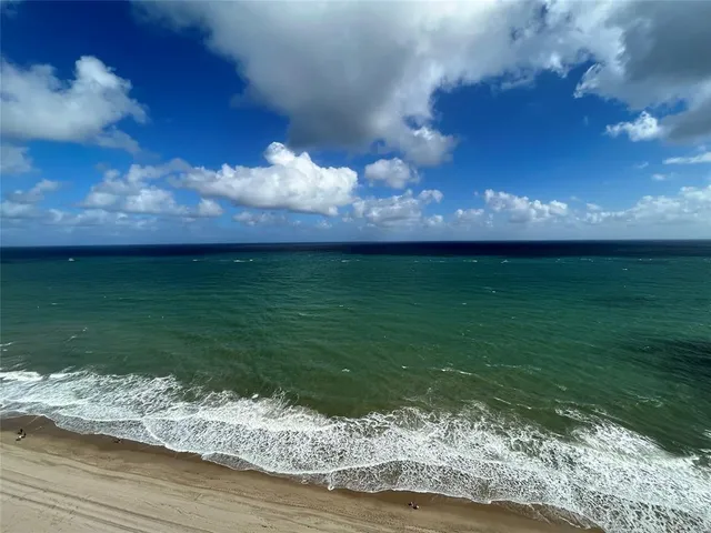 an empty room with sliding glass door and mountain view