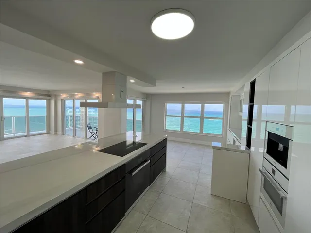 a bathroom with a sink a toilet a mirror and shower