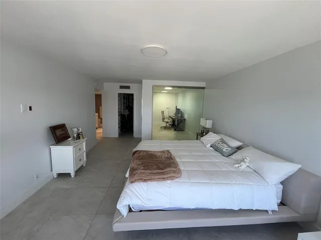 a living room with couch and wall painting