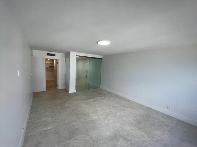 a view of a building and trees in the background