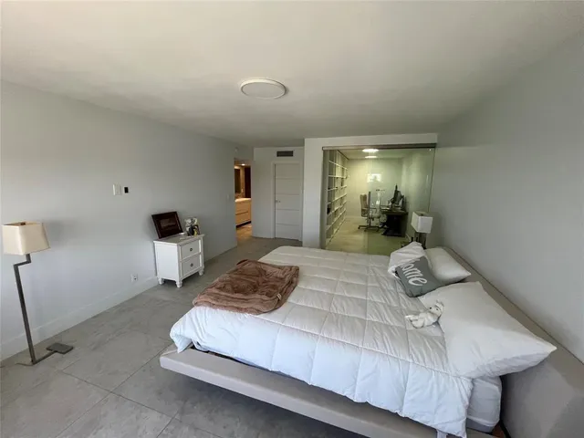 a front view of a house with a tree