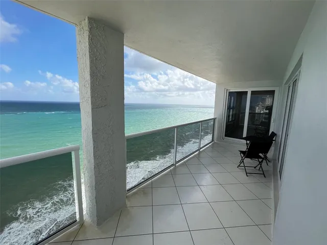 a view of empty room with wooden floor and cabinet