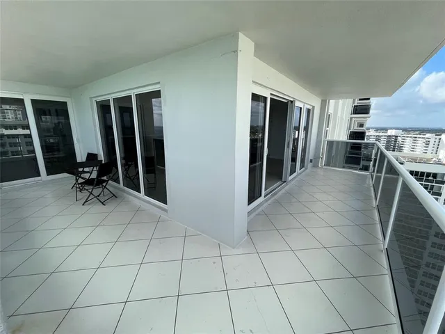 a view of a livingroom with furniture and floor to ceiling window