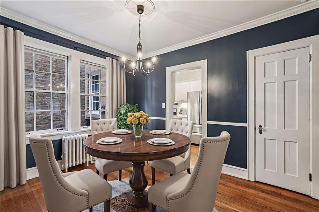 8 Collier Road Northwest, Unit A1 Atlanta, GA 30309 - Photo 12 of 31 a view of a dining room with furniture window and wooden floor