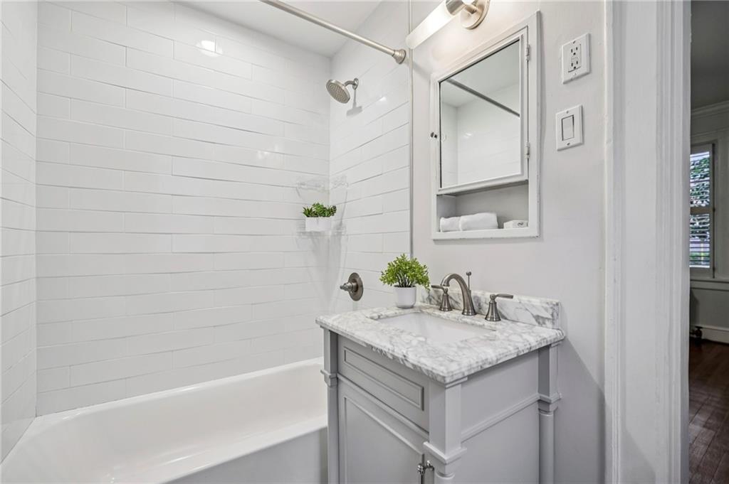8 Collier Road Northwest, Unit A1 Atlanta, GA 30309 - Photo 21 of 31 a bathroom with a granite countertop sink and a mirror