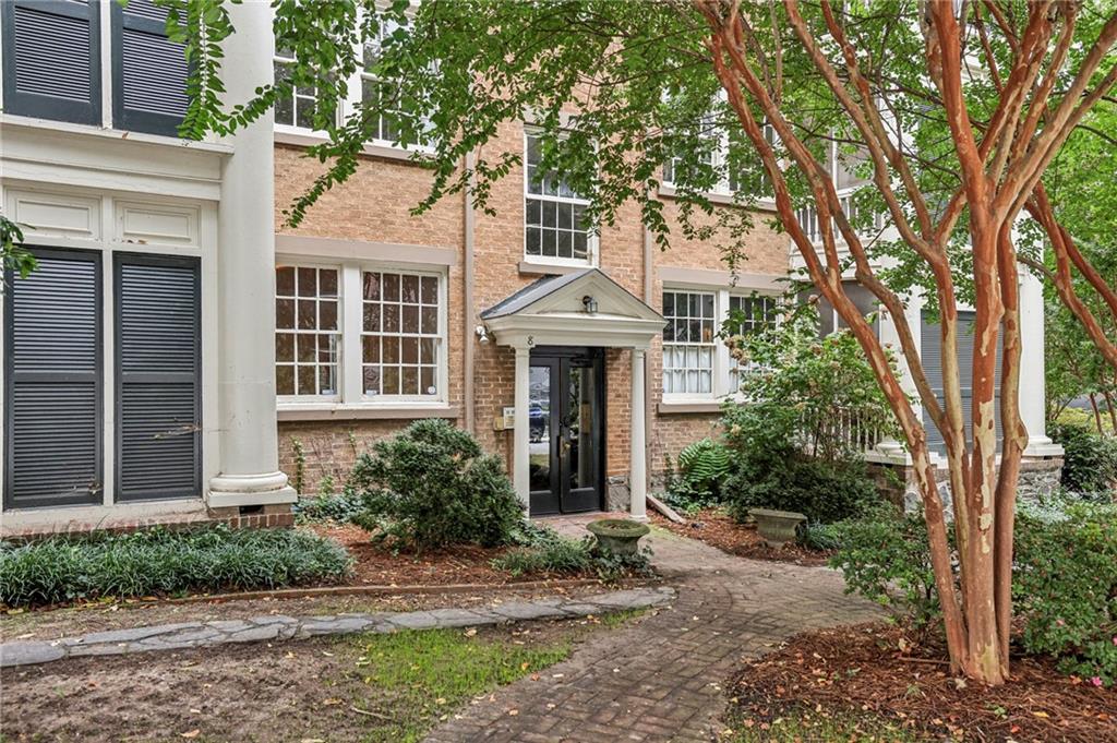 8 Collier Road Northwest, Unit A1 Atlanta, GA 30309 - Photo 27 of 31 a front view of a house with garden