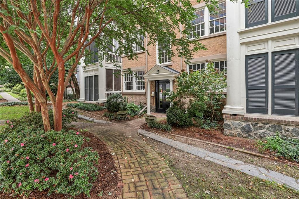 8 Collier Road Northwest, Unit A1 Atlanta, GA 30309 - Photo 28 of 31 a front view of a house with garden