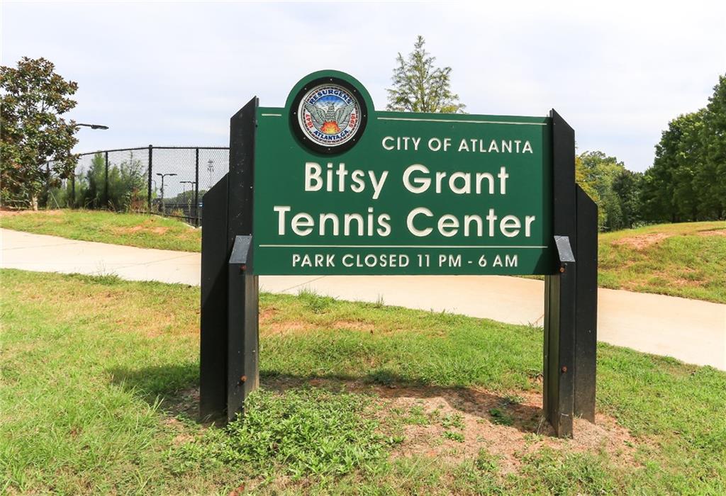 8 Collier Road Northwest, Unit A1 Atlanta, GA 30309 - Photo 30 of 31 a sign broad in front of the tree