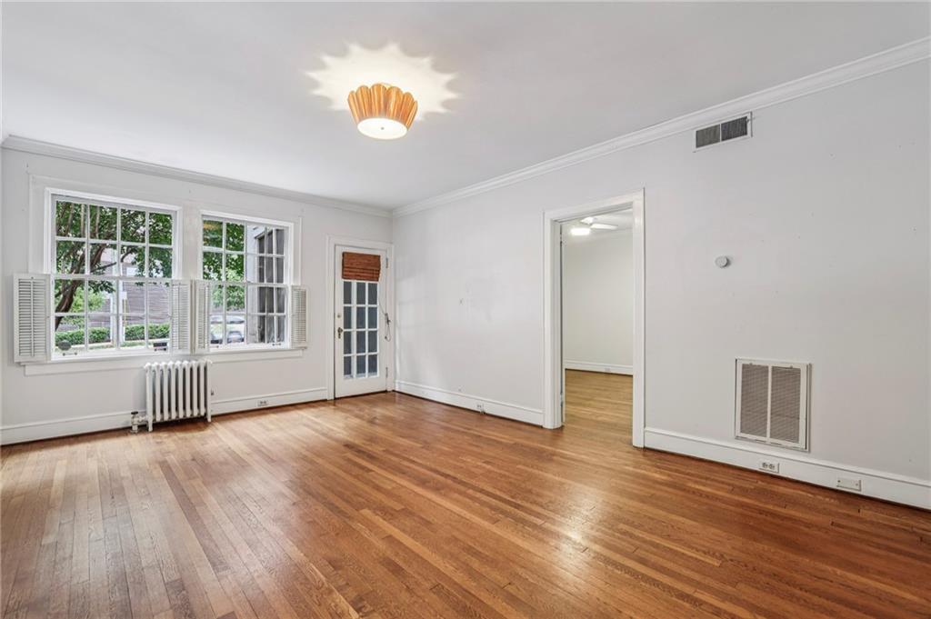 8 Collier Road Northwest, Unit A1 Atlanta, GA 30309 - Photo 4 of 31 a view of an empty room with wooden floor and a window