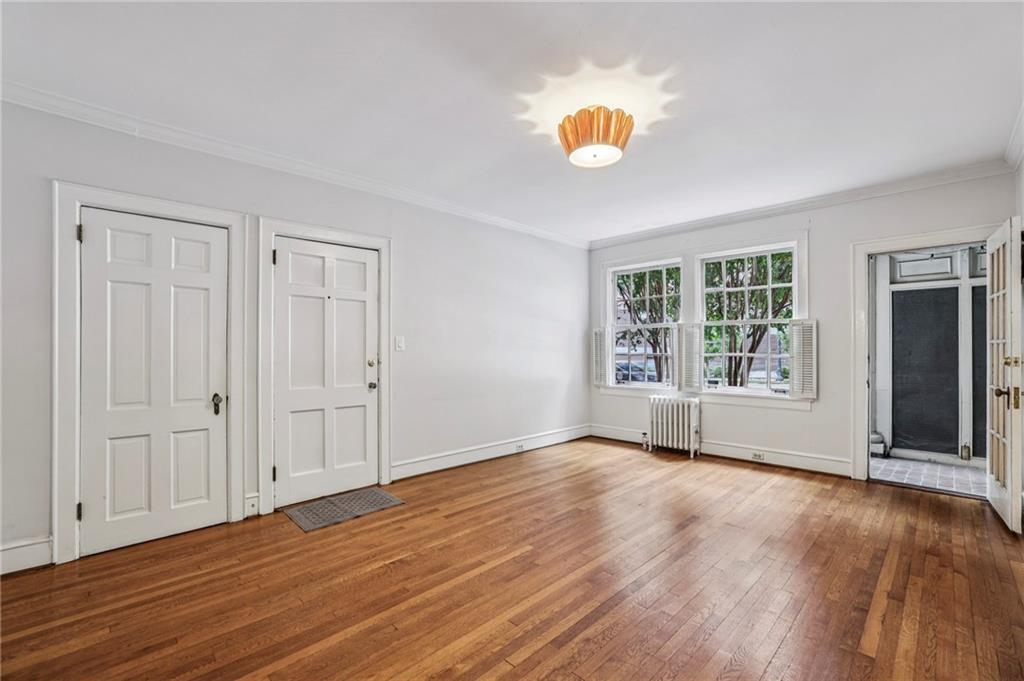 8 Collier Road Northwest, Unit A1 Atlanta, GA 30309 - Photo 7 of 31 an empty room with wooden floor and windows