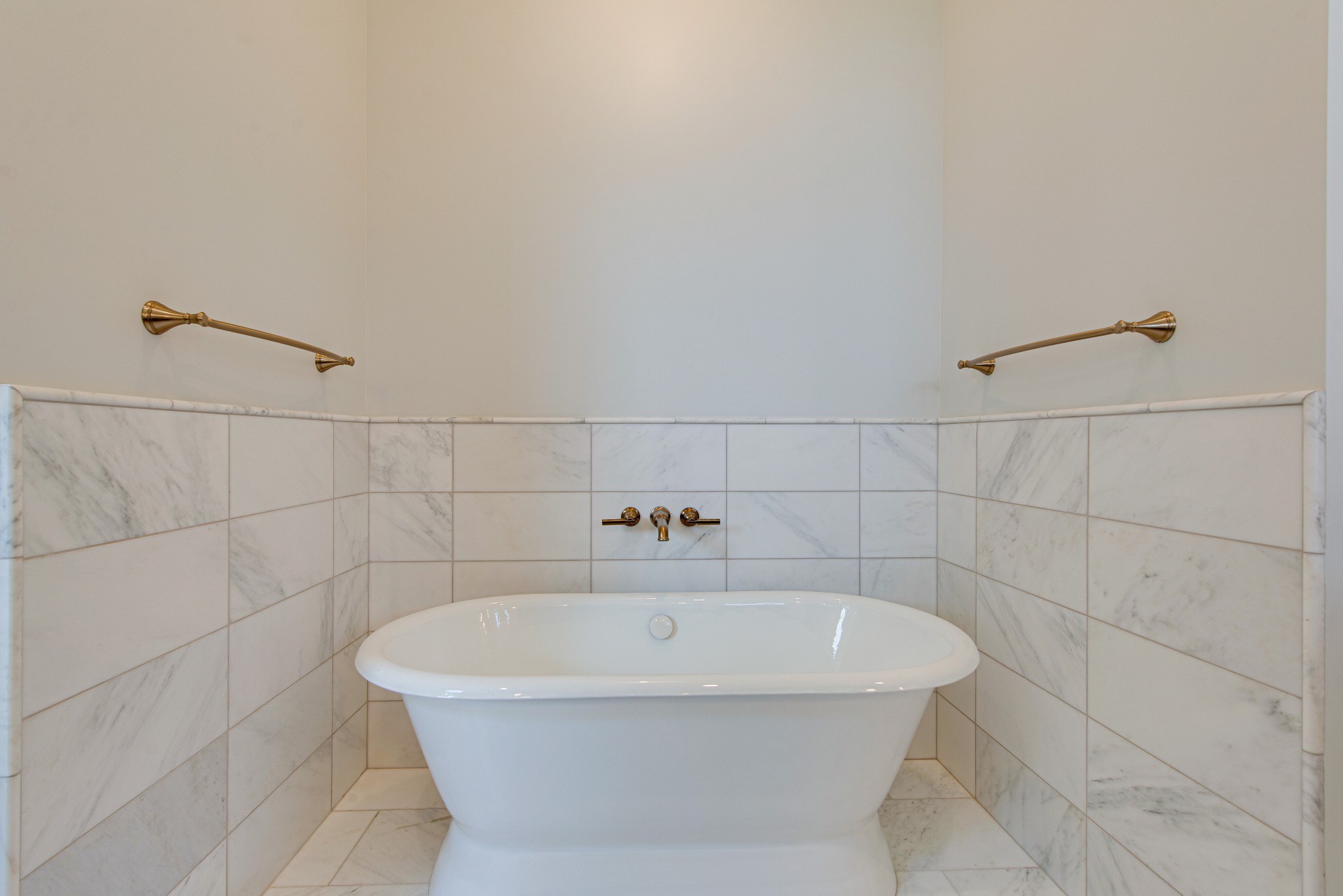 2111 Natchez Trace Nashville, TN 37212 - Photo 17 of 41 a white bath tub sitting in a bathroom